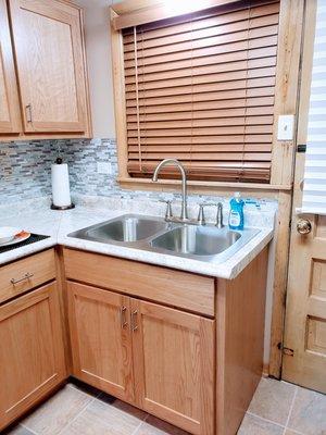 After adding backsplash, new sink faucet, and countertops