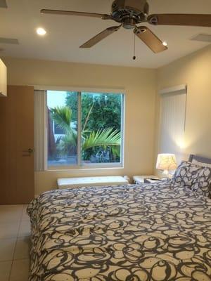 Master bedroom with flat screen TV and a relaxing view to the sun deck and the water cascade.