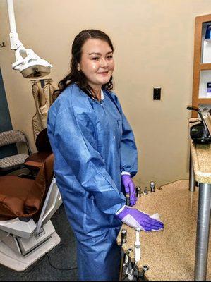 Student learning infection control and how to properly wipe down the dental treatment room