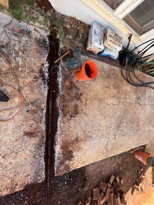 Exposing leaking galvanized water line. Busting through concrete in driveway. Replaced with 3/4" copper line and poured concrete back.