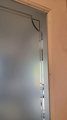 Using an air staple gun, we replaced the frame wood to hold the glass in place using 1" 18g staples.