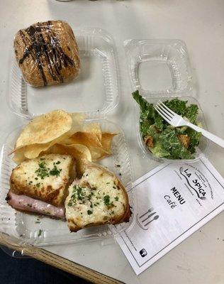 Croque monsieur sandwich with homemade chips and Caesar salad. Also a chocolate croissant.