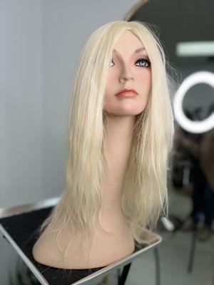 Russian Human Hair wig that is light blonde with beach wave texture.