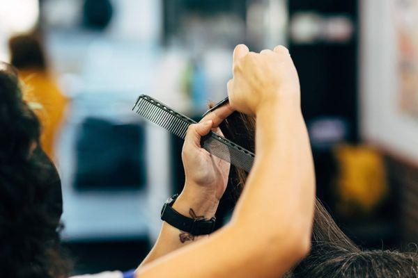 Vanessa carefully executes a customized haircut