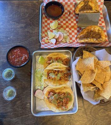 Pollo asada street tacos and queso barria tacos with chips and salsa.