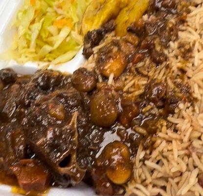 oxtail, cabbage, and plaintain with rice and peas