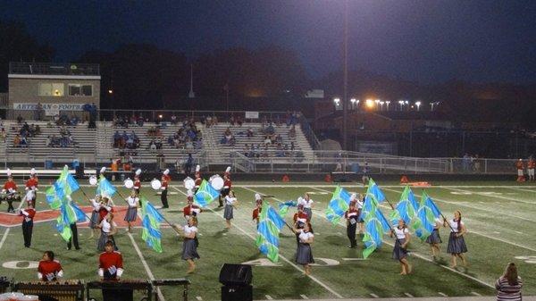 The Marching Artesians take the field at a home football game.
