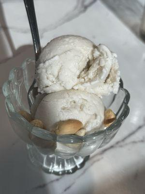 Coconut ice cream topped with peanuts