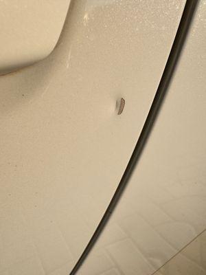 dent near door handle.