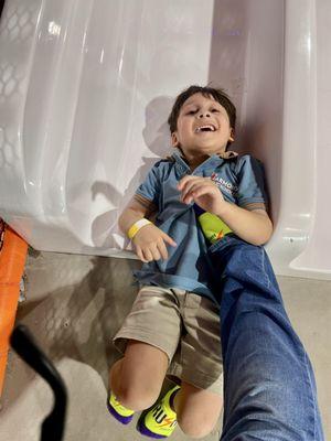 Try to stop him from falling on his tush