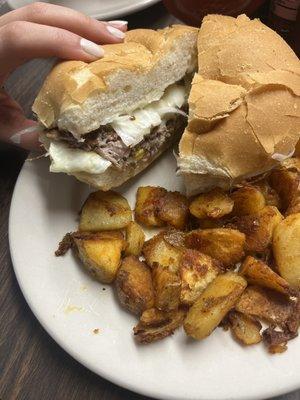 Steak, egg, and cheese sandwich! With home fries