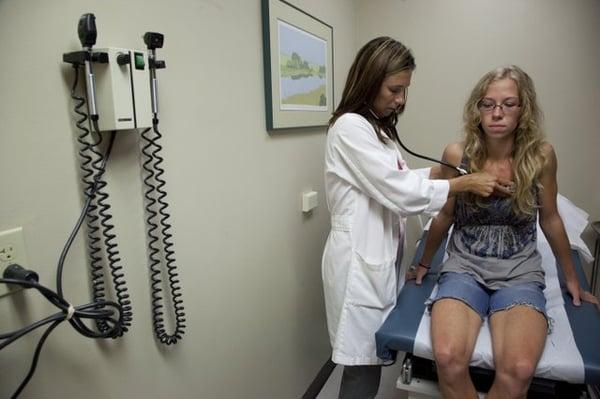 Our medical director with a patient. Photo credit: Nick Krug at the LJWorld