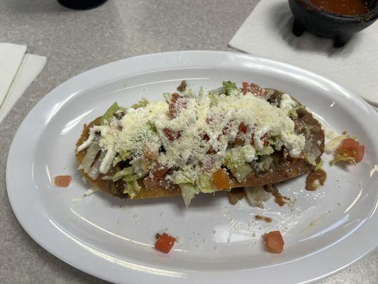 Huarache, a thick crunchy base, like a very thick tostado with refried beans and steak then toppings.