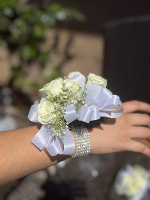 Corsage wristlet with 4 white, baby roses, babies breath and keepsake rhinestone bracelet.