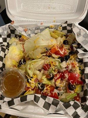 Salad with bacon that the chicken bone came from