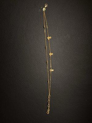 24 kt cross bracelet.