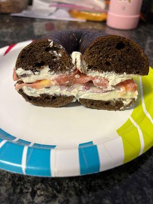 Pumpernickel bagel with cream cheese, tomato, onion and capers