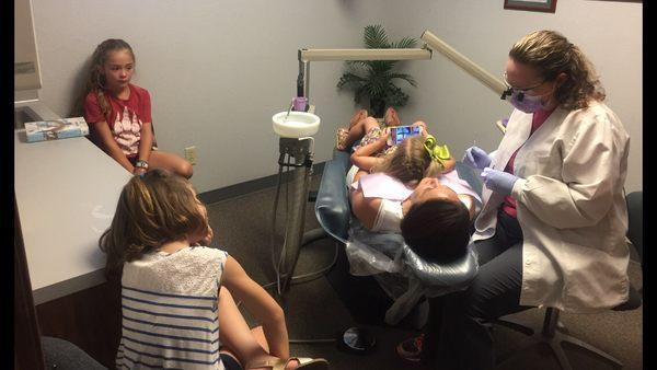 Carla, our Dental Hygienist, working on third and fourth generation members of a family we have been taking care of since 1980 !