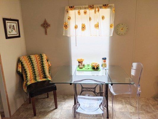 Ghost chairs and glass table top so you can enjoy the old sewing machine base.