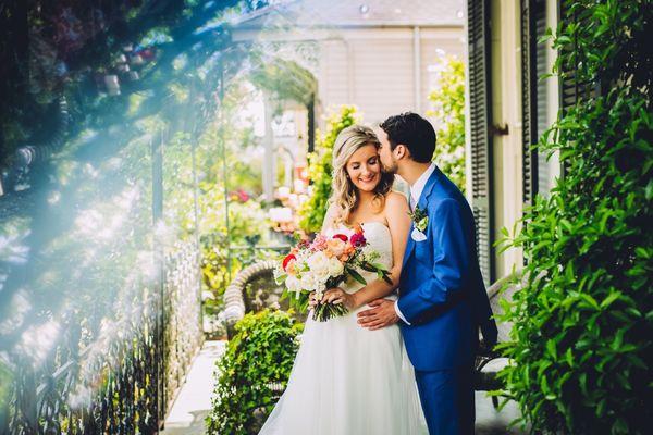 Bride and groom surrounded by some NOLA beauty on the balcony at the Terrell House.