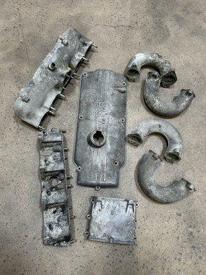 Aluminum BMW engine parts before being cleaned up with glass beads from sand blasting.