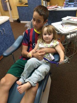 I love this dental office! They let elly sit on her brother's lap for her first check up. Now she's a pro.
