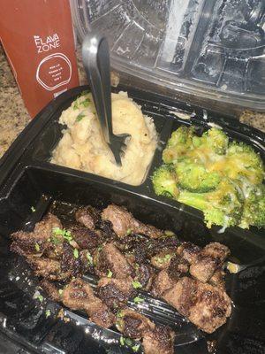Steak bites, broccoli w/ cheddar cheese on top, mashed potatoes, and Flava Zone strawberry drink.