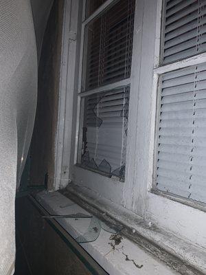 Broken window from a dangerous tenant that Fader knowingly rented an apartment out next to