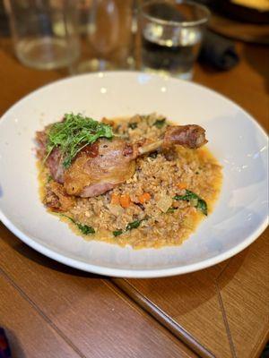 Duck confit with braised farro, kale, gremolata, and fresh herbs