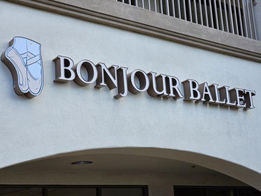 The sign features the trademarked slipper logo and pink faces copy mounted on the façade of the suite.