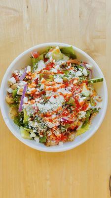 Chicken souvlaki bowl, build your own, with fresh ingredients, topped off with premium feta cheese and hot sauce! Don't forget the dill.