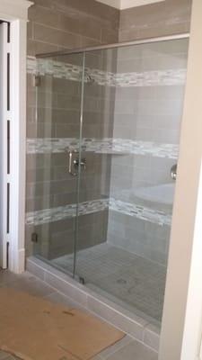 Frameless shower door with 3 / 8 glass clear with header on top