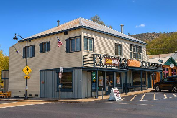 Corner of Main Street (Highway 140) and 7th Street. Just above Subway.