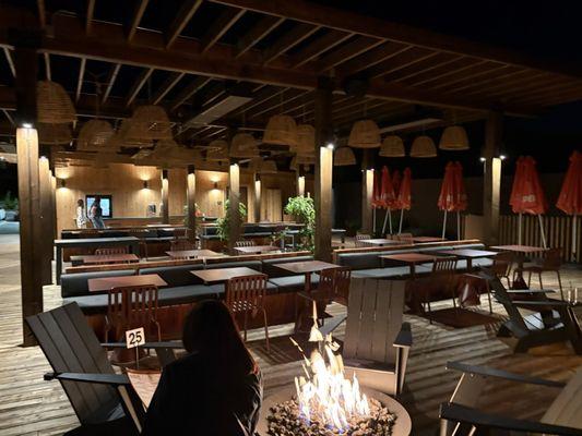 Separate seating area on the outdoor back deck complete with heaters and extra receiving fire pits