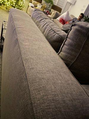 Another shot of wavy side and arm. Cushions are under-filled and don't match the look of the arms.