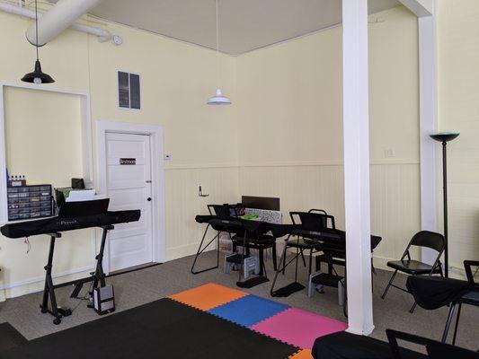 The classroom has room for eight students to sit at their own keyboards.