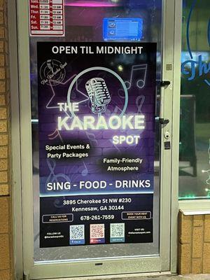 One of the front doors displaying information about the Karaoke Spot