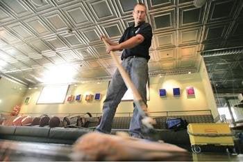 Thomas Whitby applies a final coat of finish to a commercial wood floor in Telluride.