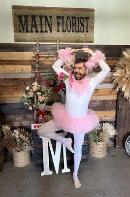Nothing says 'I lost a bet' like a full tutu, ruffled bloomers, and a rose clenched between your teeth. Thanks, Main Florist!