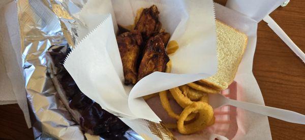 Ribs and smoked wings with onion rings.