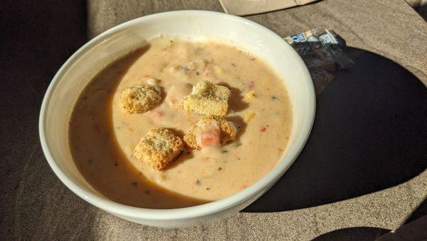The sun streaming in on a piping hot bowl of Shrimp and Corn Chowder on a crisp, fall day. The chowder is thick, rich, and very tasty!