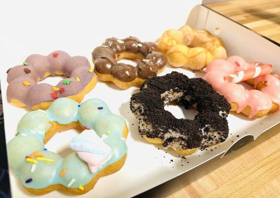 Half Dozen Mochi Donuts.  Flavors, clockwise from upper left: Ube, Nutella, Churro, Strawberry, Oreo, & Cotton Candy