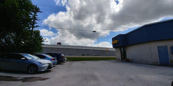 The building is as dirty as the cars