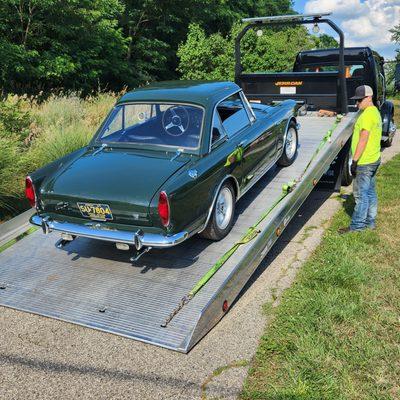 Our classic 1967 Sunbeam Tiger being loaded on Hansen's flatbed trailer.