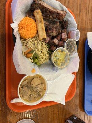 Lunch Plate 3 Choice with pork ribs, smoked pork pieces, and spicy chicken. Also rice, lumpia, noodles, and cucumber salad.
