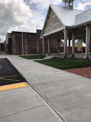 Pavilion, 2 accessible parking spaces up front, view down the street.
