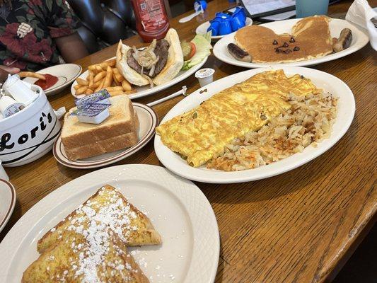 Lori's Supreme Omelet Mess', Steak ribeye sandwich, and Mickey Mouse pancakes