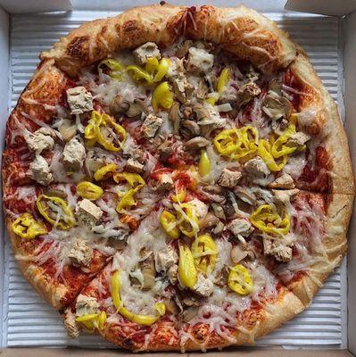 Vegan pizza with chicken, mushrooms, and pepper rings