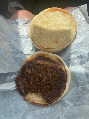 McDonald's hamburger served with what looks like a bite taken out of the patty.