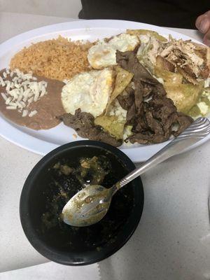Chilaquiles Verdes with chicken, steak and two eggs. Side of rice and beans.